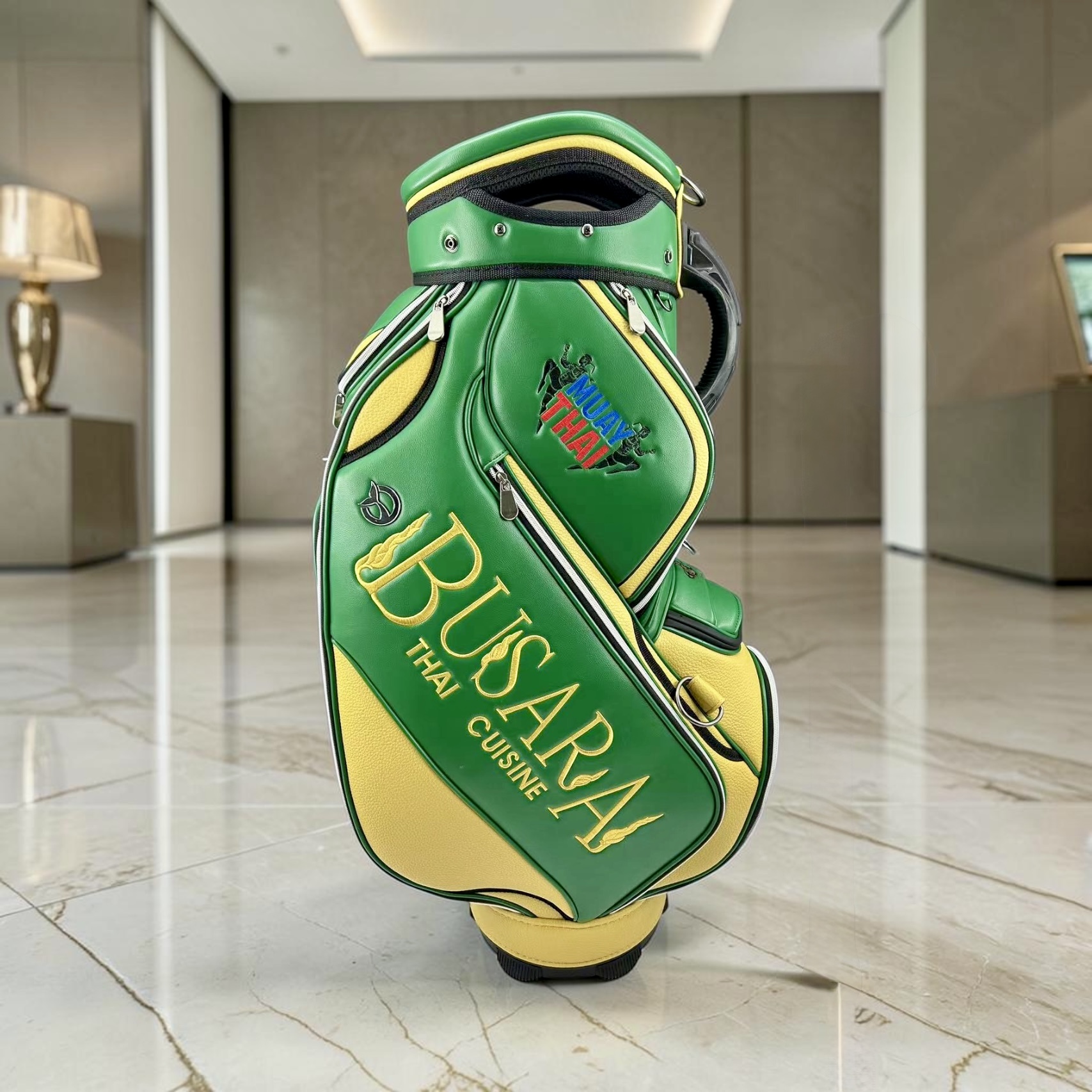 Busara Thai Cuisine green and yellow custom staff bag with embroidered Muay Thai crest